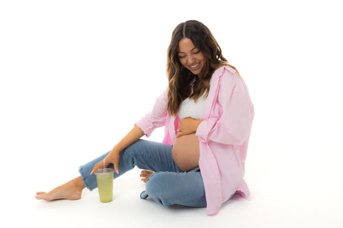 pregnant woman holding belly sitting