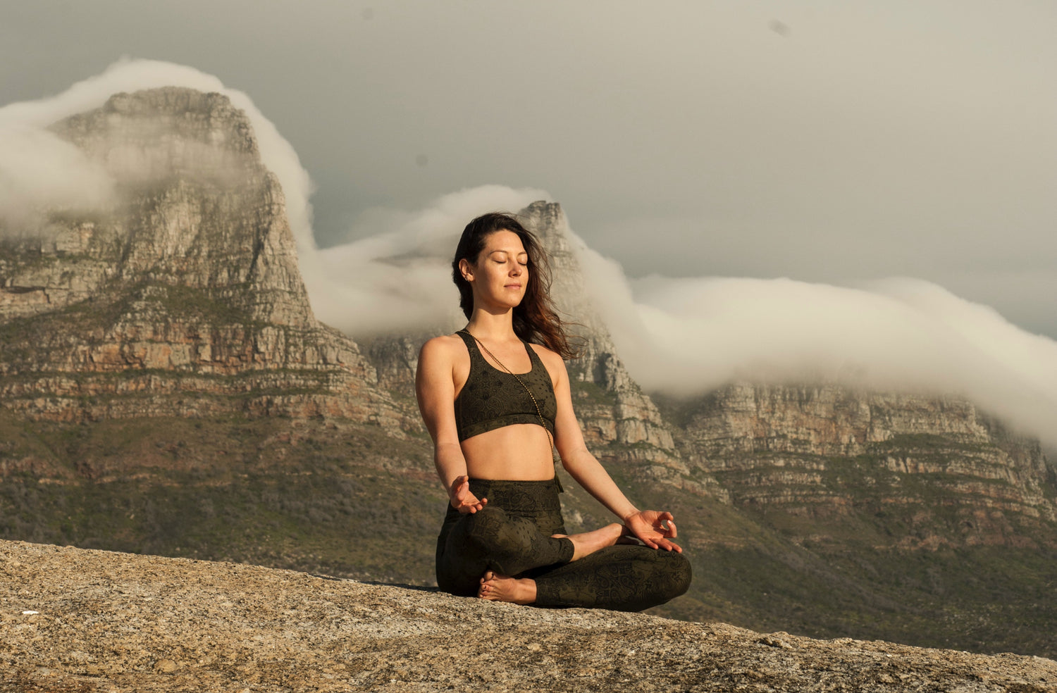 meditating woman on mountain